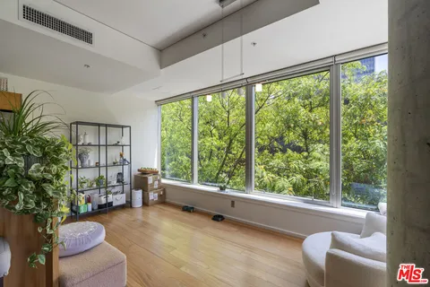 a kitchen with stainless steel appliances granite countertop a table chairs in it and wooden floor