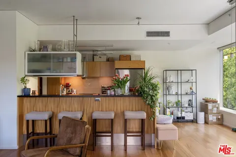 a kitchen with stainless steel appliances a sink stove and cabinets