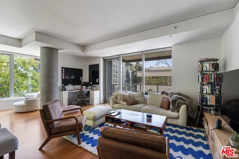 a living room with furniture wooden floor and a flat screen tv