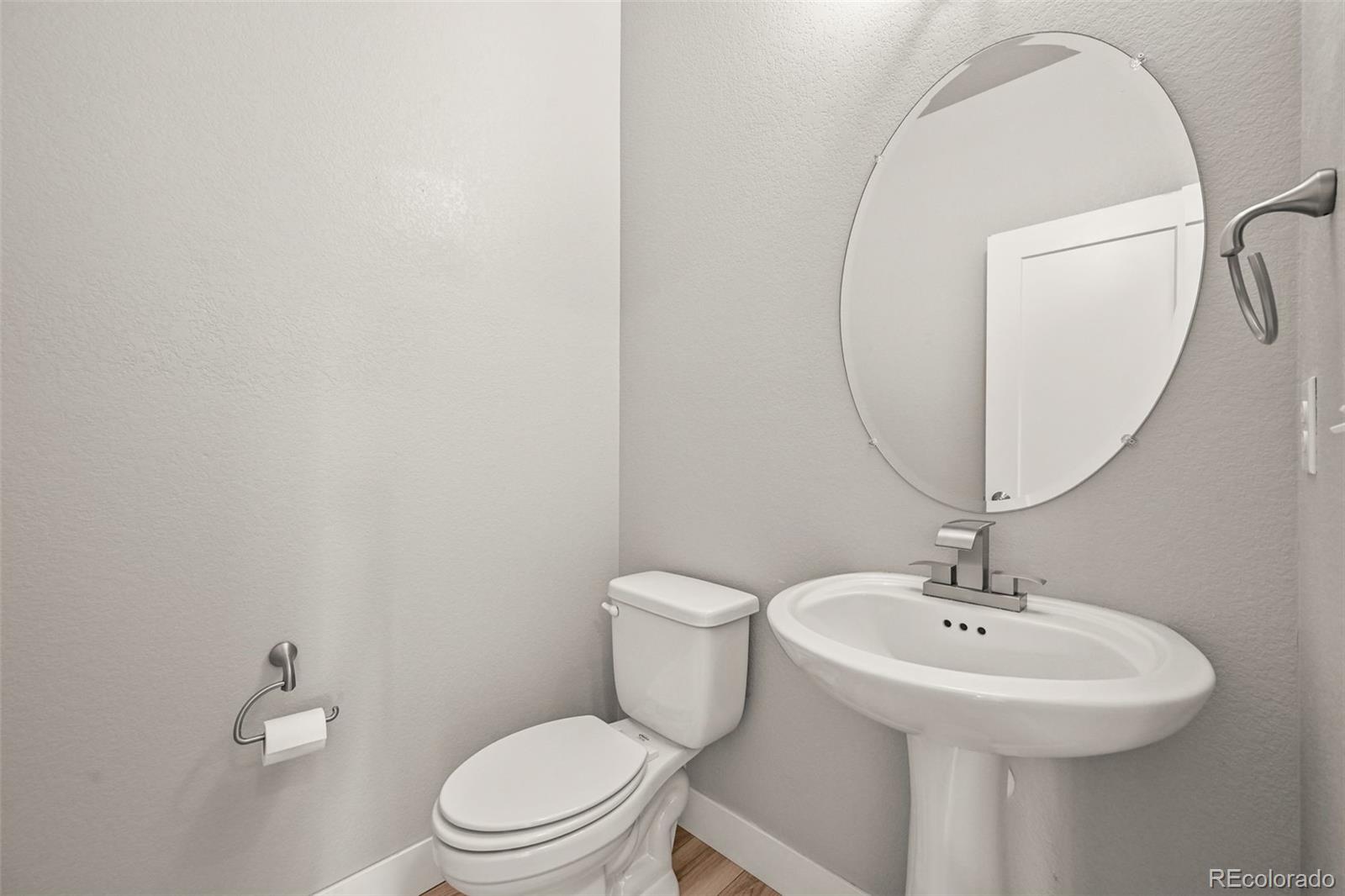 2880 West 69th Avenue Denver, CO 80221 - Photo 22 of 45 a bathroom with a toilet sink and mirror