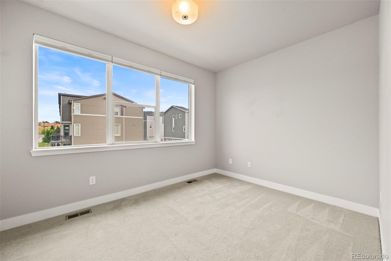 2880 West 69th Avenue Denver, CO 80221 - Photo 26 of 45 a view of an empty room with a window