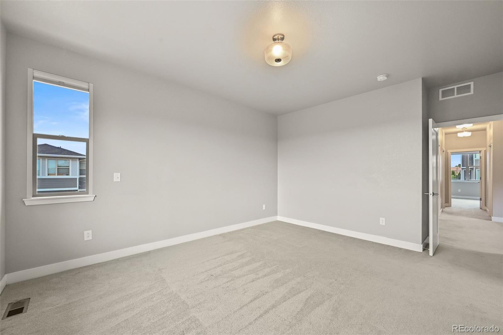 2880 West 69th Avenue Denver, CO 80221 - Photo 27 of 45 a view of an empty room with a window