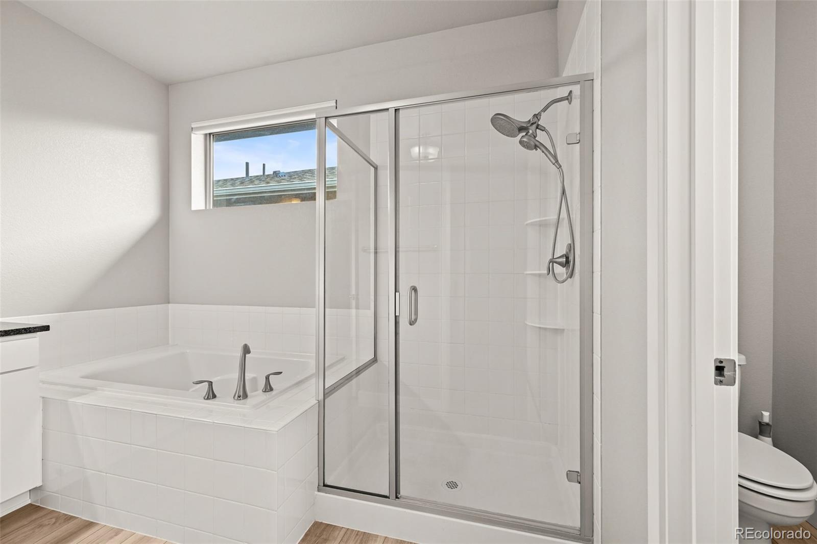 2880 West 69th Avenue Denver, CO 80221 - Photo 28 of 45 a bathroom with a bathtub and a shower