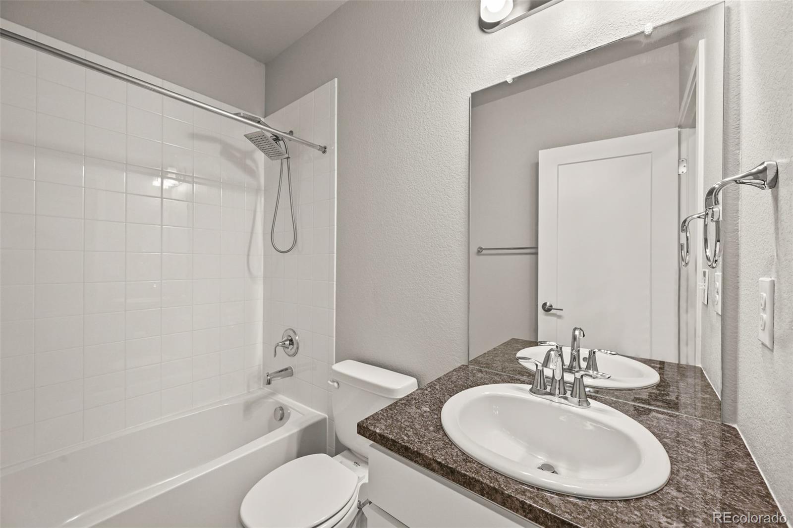 2880 West 69th Avenue Denver, CO 80221 - Photo 31 of 45 a bathroom with a granite countertop sink toilet and shower