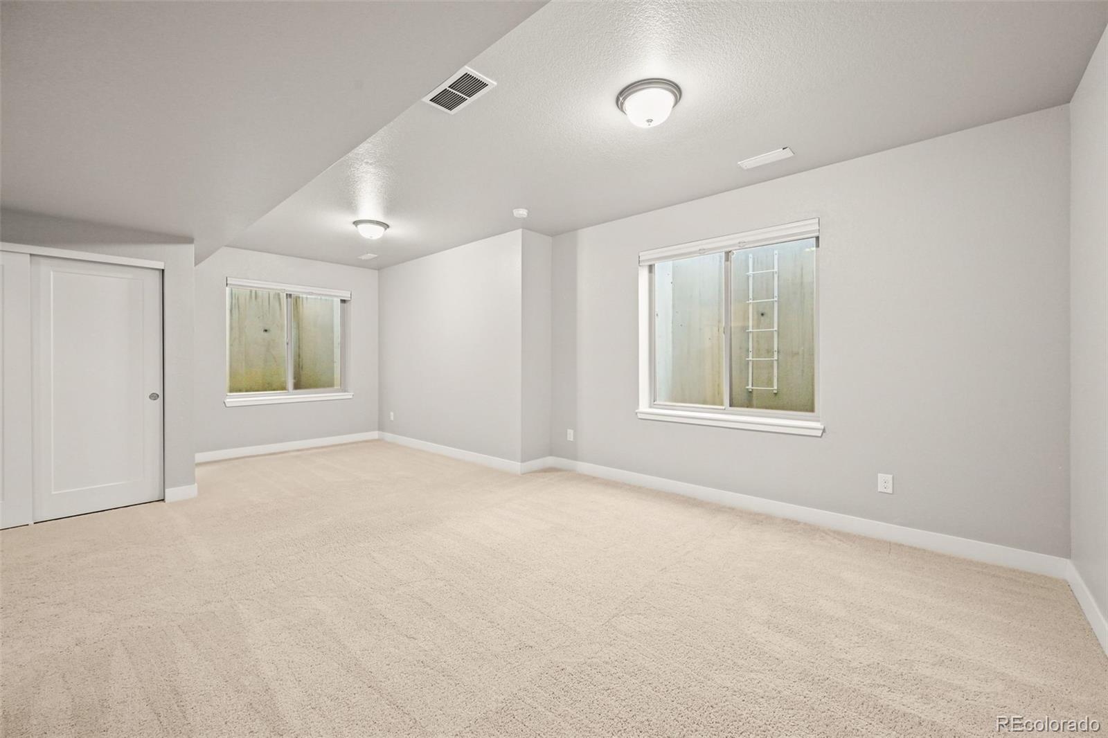 2880 West 69th Avenue Denver, CO 80221 - Photo 36 of 45 an empty room with windows and closet