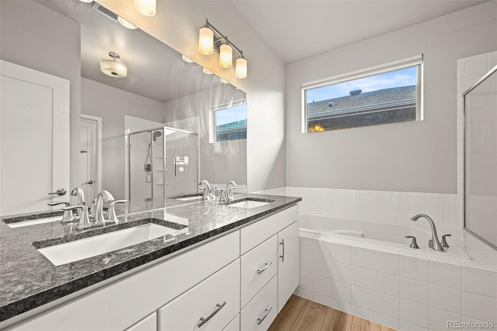 2880 West 69th Avenue Denver, CO 80221 - Photo 10 of 45 a bathroom with a granite countertop sink mirror and double