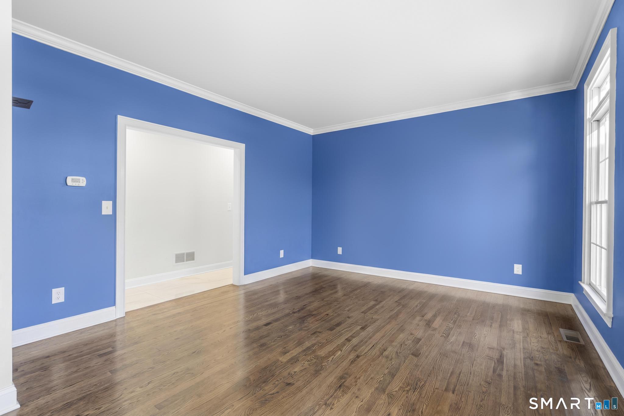 13 Surrey Lane Monroe, CT 06468 - Photo 14 of 40 a view of an empty room with wooden floor and a window