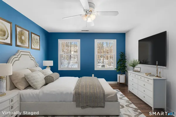 a view of room with window ceiling fan and hardwood floor
