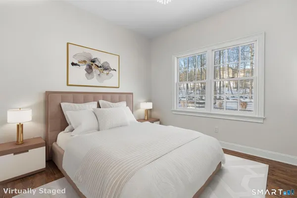 a bedroom with a large bed and a flat tv screen on a dresser