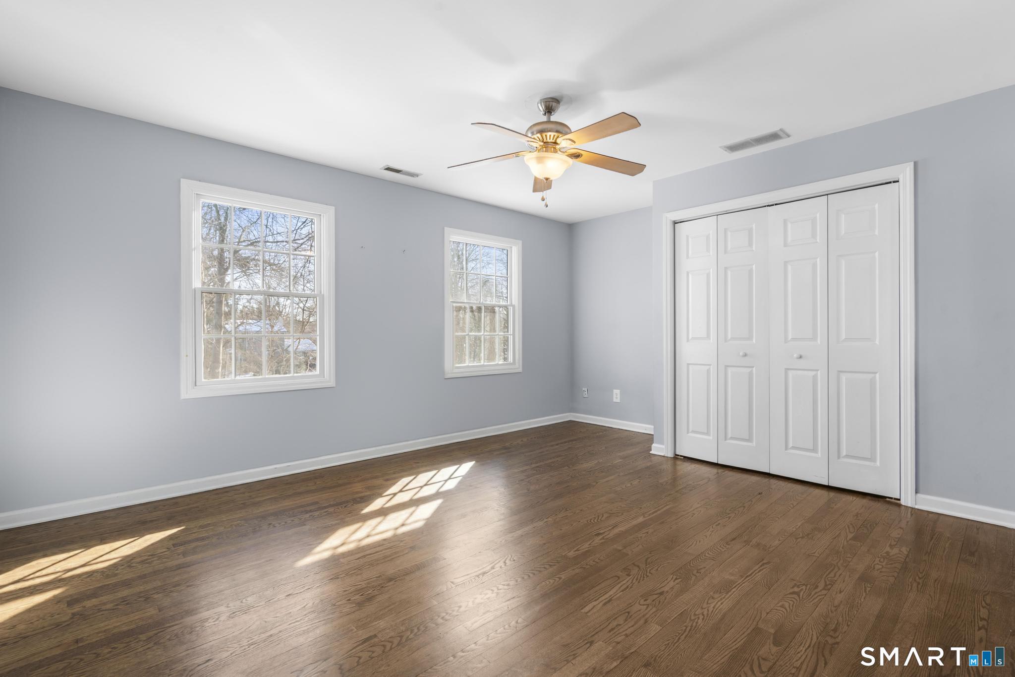 13 Surrey Lane Monroe, CT 06468 - Photo 20 of 40 a view of an empty room with wooden floor and a window