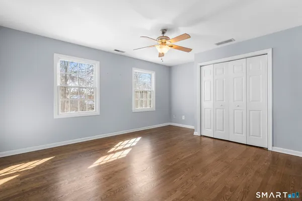a spacious bedroom with a bed a couch and a window