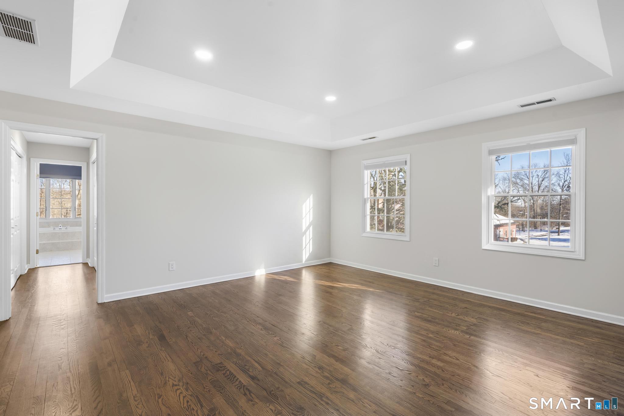 13 Surrey Lane Monroe, CT 06468 - Photo 22 of 40 a view of an empty room with wooden floor and a window