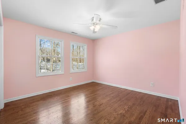 a bedroom with bed and a potted plant