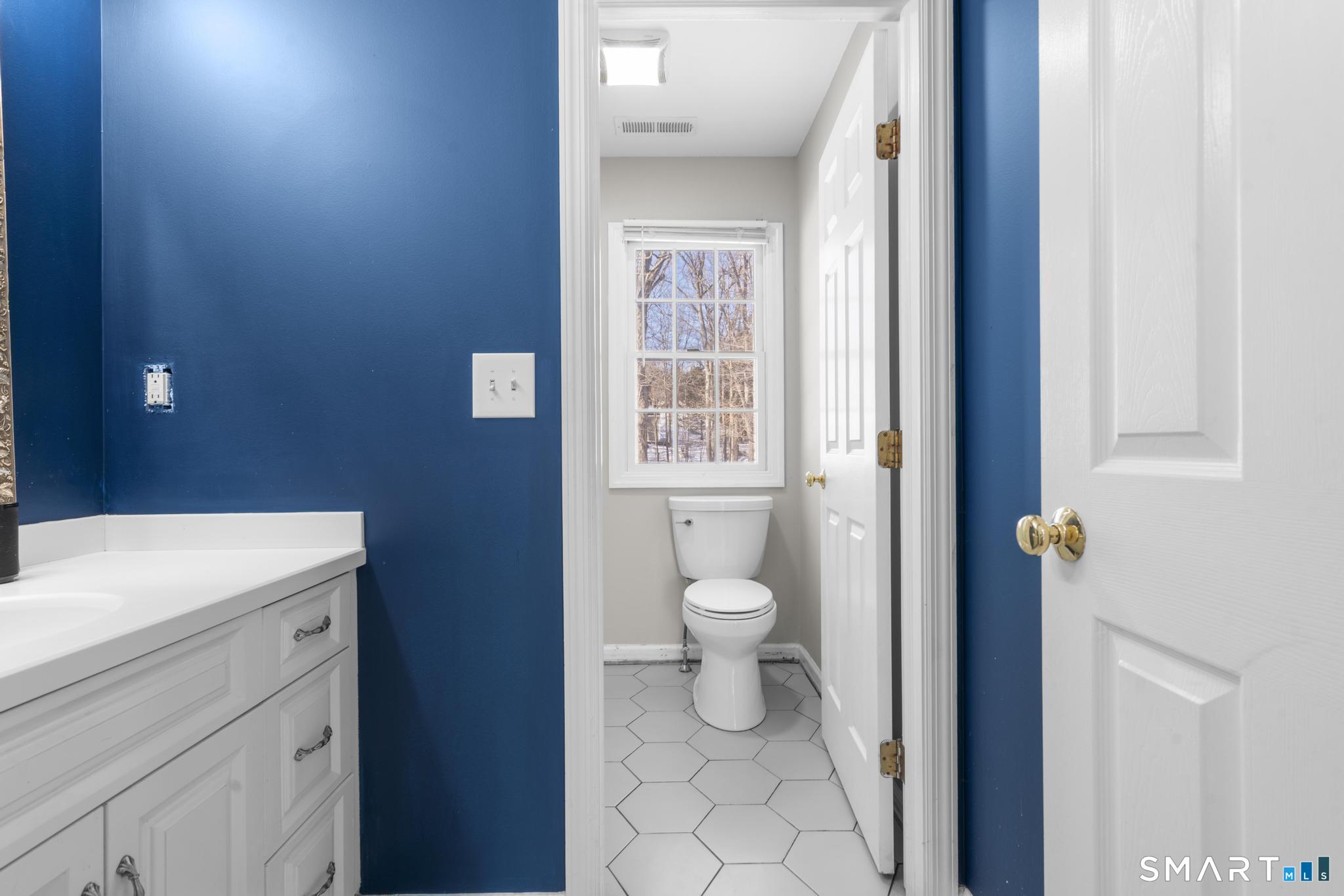 13 Surrey Lane Monroe, CT 06468 - Photo 25 of 40 a bathroom with a toilet a sink and a window