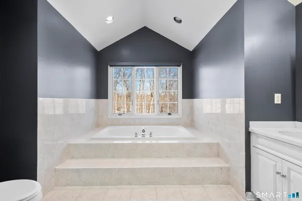 a spacious bathroom with a double vanity sink toilet and shower