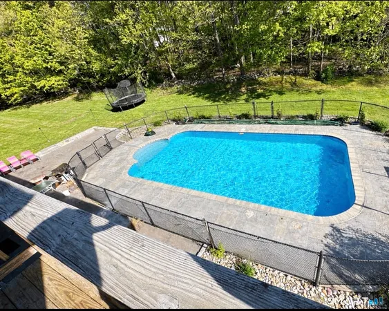 a view of swimming pool with a yard