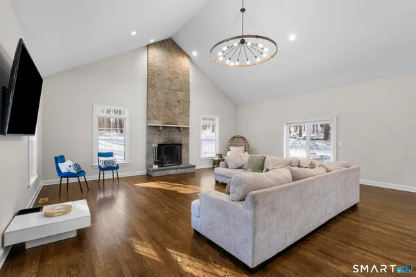 a living room with furniture a fireplace and a flat screen tv