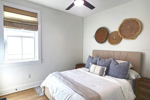 a bedroom with a bed and a window