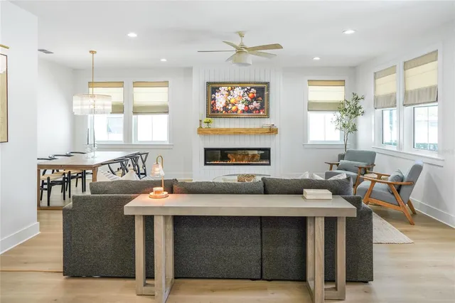 a living room with fireplace furniture and a large window