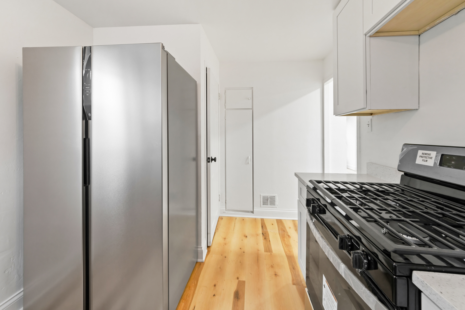 28 Dunlap Road Park Forest, IL 60466 - Photo 13 of 17 a kitchen with white cabinets and stainless steel appliances