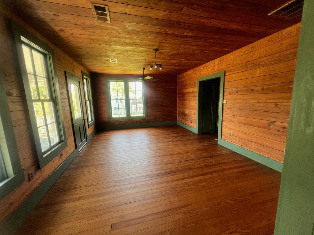 618 Bayridge Road La Porte, TX 77571 - Photo 11 of 50 This inviting living room features warm wood paneling, abundant natural light, and a cozy ambiance perfect for relaxation.