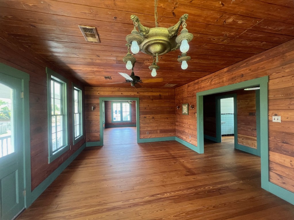 618 Bayridge Road La Porte, TX 77571 - Photo 13 of 50 Discover the charm of this dining room, featuring warm wood paneling and ample natural light for cozy gatherings.