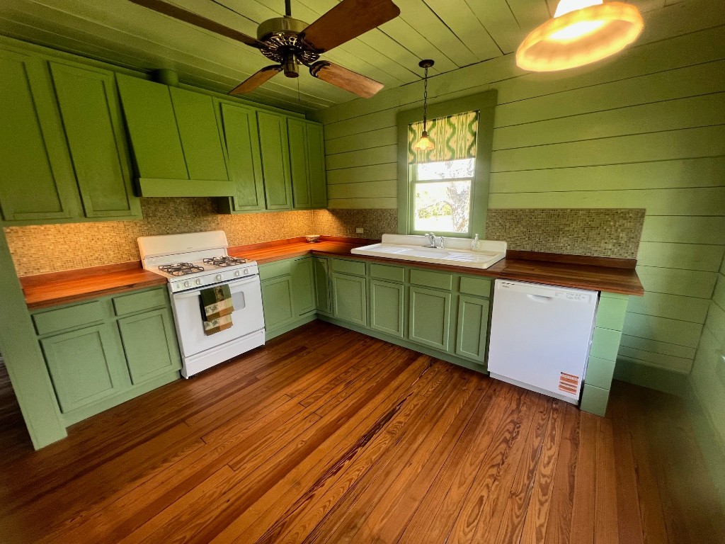 618 Bayridge Road La Porte, TX 77571 - Photo 15 of 50 Experience the allure of this kitchen with vibrant green cabinetry and a striking glass mosaic backsplash, designed to spark your culinary creativity.