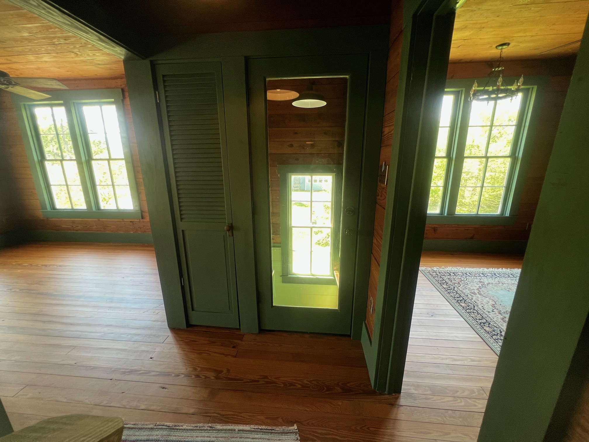 618 Bayridge Road La Porte, TX 77571 - Photo 20 of 50 This hallway, with its rich wooden floors and abundant natural light, leads seamlessly to a charming kitchen.