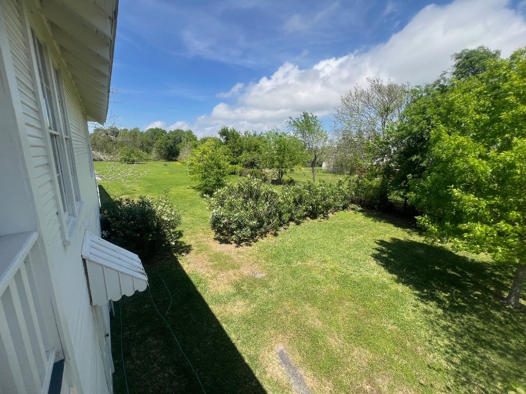 618 Bayridge Road La Porte, TX 77571 - Photo 7 of 50 Experience a breathtaking side view of the magnificent yard, offering lush greenery and serene open space perfect for relaxation and outdoor enjoyment.