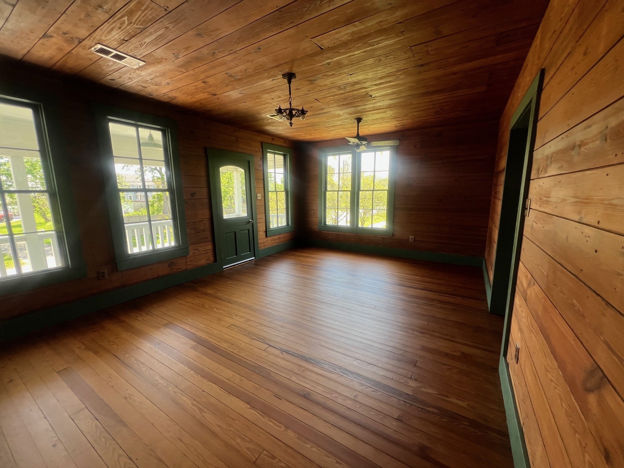 618 Bayridge Road La Porte, TX 77571 - Photo 9 of 50 Discover rustic charm in this cozy living room with warm wood paneling and abundant natural light. Perfect for relaxation and gatherings.
