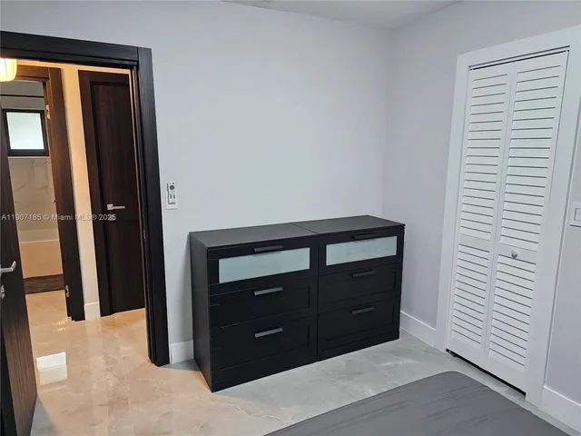a room with a dresser and mirror