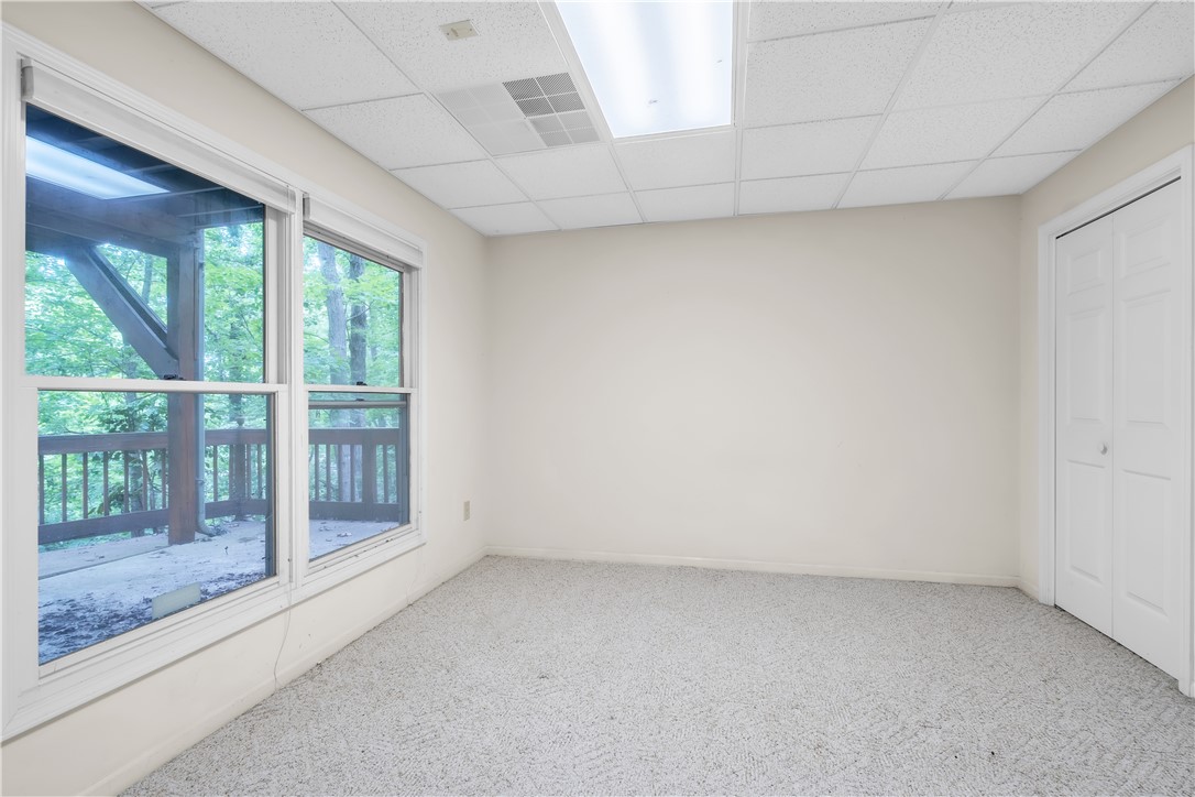 149 Inlet Pointe Drive Anderson, SC 29625 - Photo 20 of 43 A versatile interior space featuring large windows and a subtle carpeted floor.