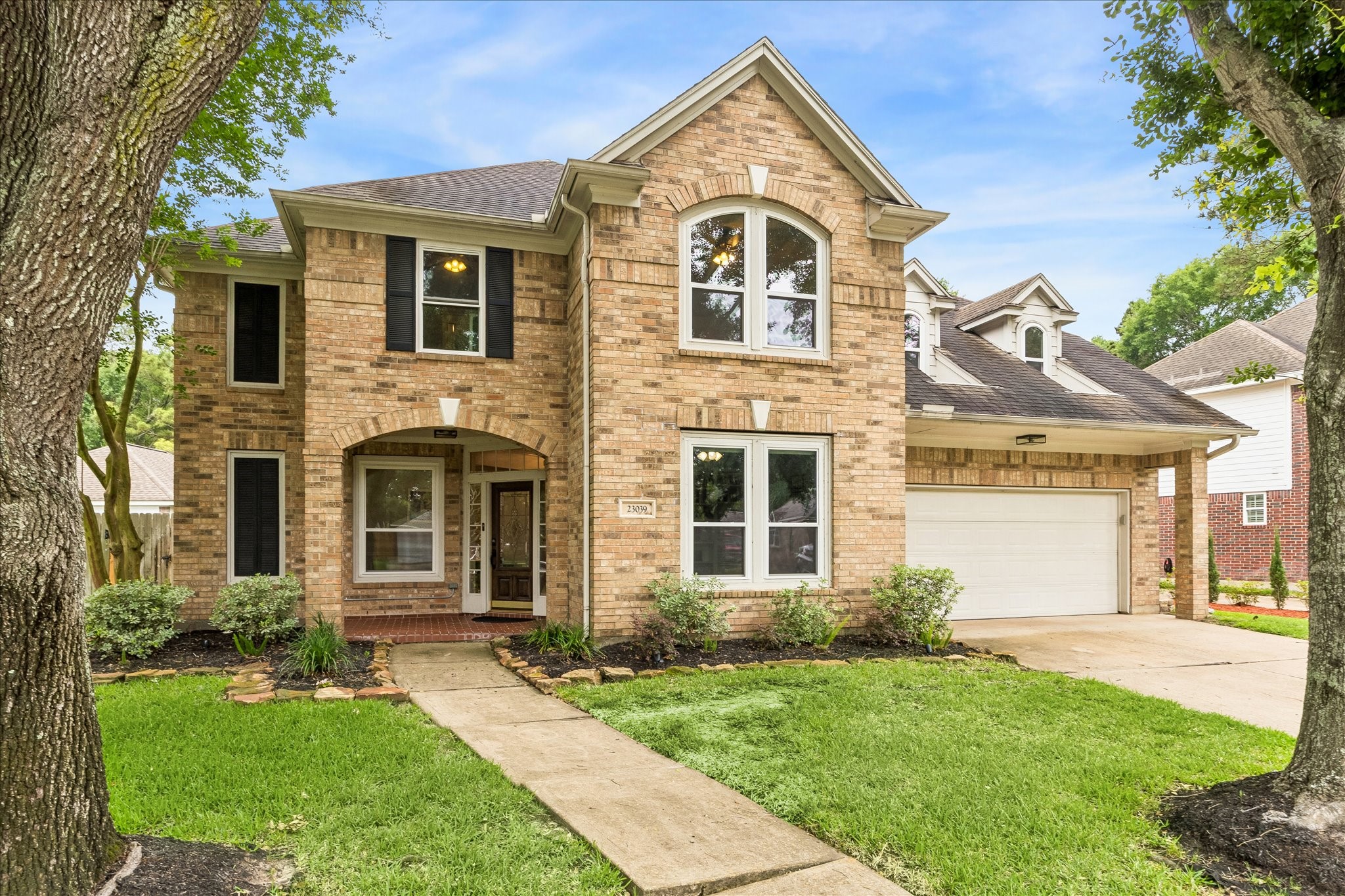 23039 Enchanted Landing Lane Katy, TX 77494 - Photo 1 of 30 a view of a brick house with a yard