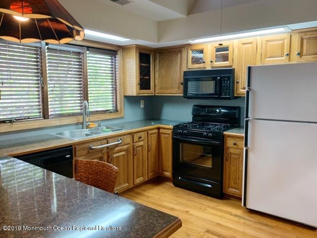 190 Jackson Mills Road Jackson, NJ 08527 - Photo 7 of 11 a kitchen with stainless steel appliances granite countertop a stove a sink and a microwave
