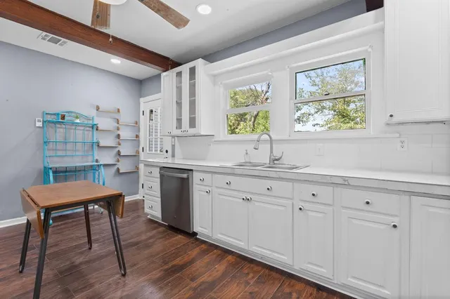 a kitchen with sink cabinets and wooden floor