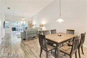 1670 Windy Pines Drive, Unit 2510 Naples, FL 34112 - Photo 4 of 9 a view of a dining room with furniture and wooden floor