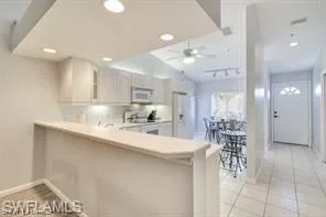 a kitchen with stainless steel appliances kitchen island granite countertop a sink and cabinets