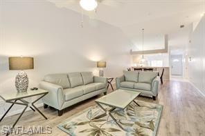 1670 Windy Pines Drive, Unit 2510 Naples, FL 34112 - Photo 7 of 9 a living room with furniture and a lamp