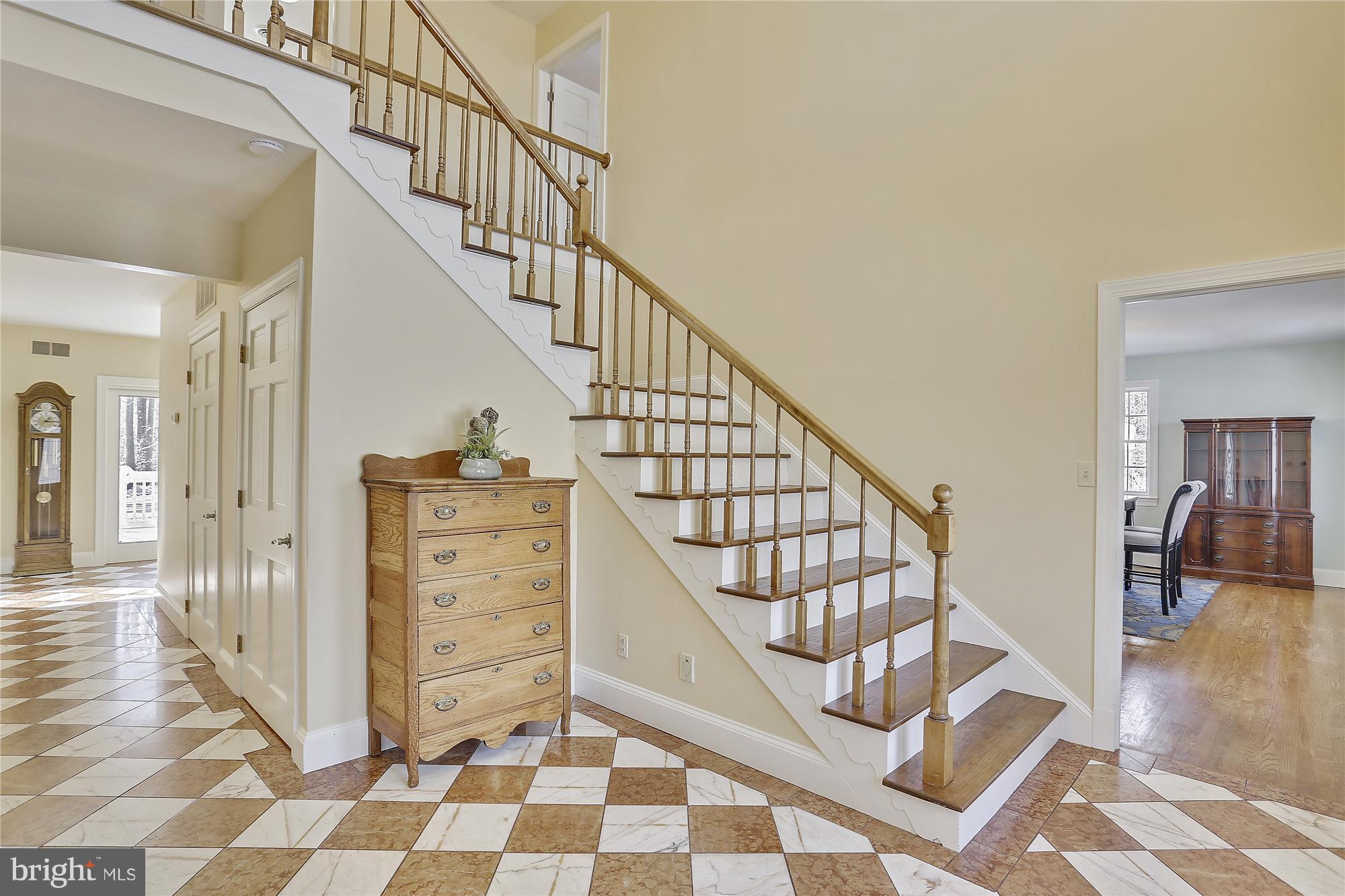 1711 Ashton Road Ashton, MD 20861 - Photo 2 of 30 a view of staircase with white walls and a black white checkered floor