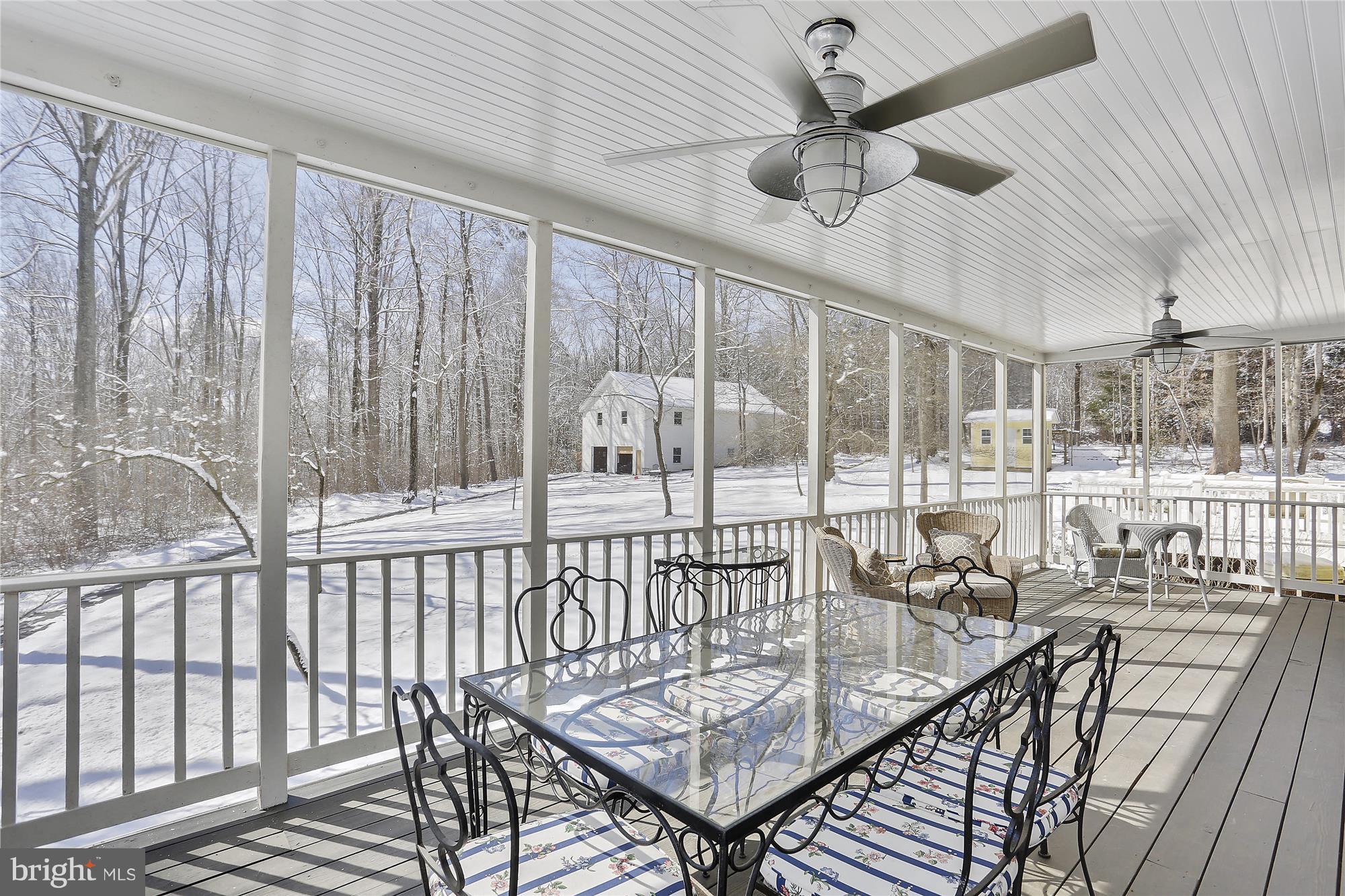 1711 Ashton Road Ashton, MD 20861 - Photo 13 of 30 a view of a balcony dining area with furniture and a chandelier