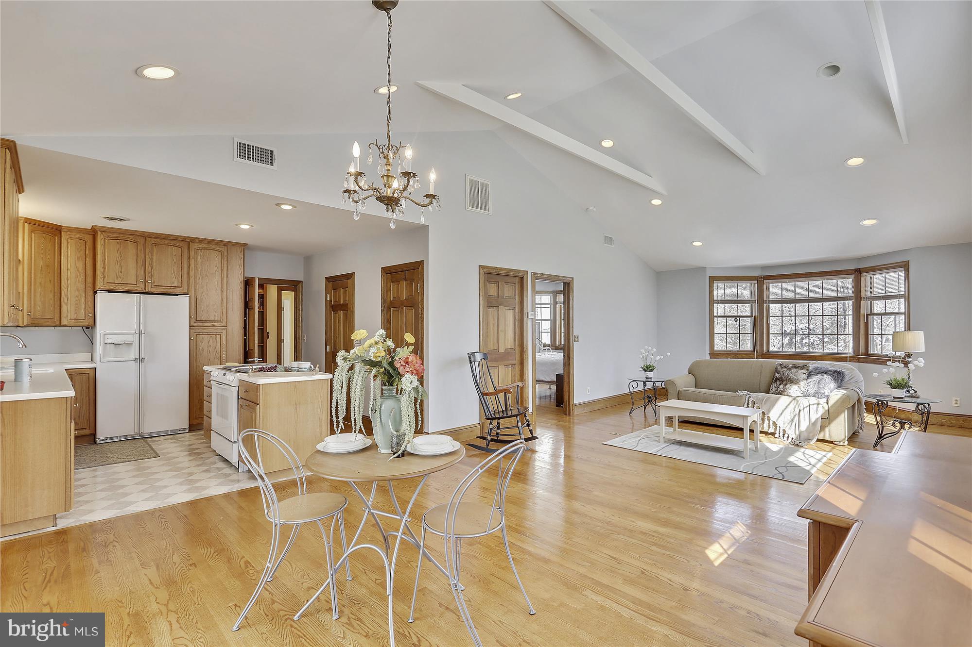 1711 Ashton Road Ashton, MD 20861 - Photo 22 of 30 a view of a dining room with furniture a kitchen and chandelier