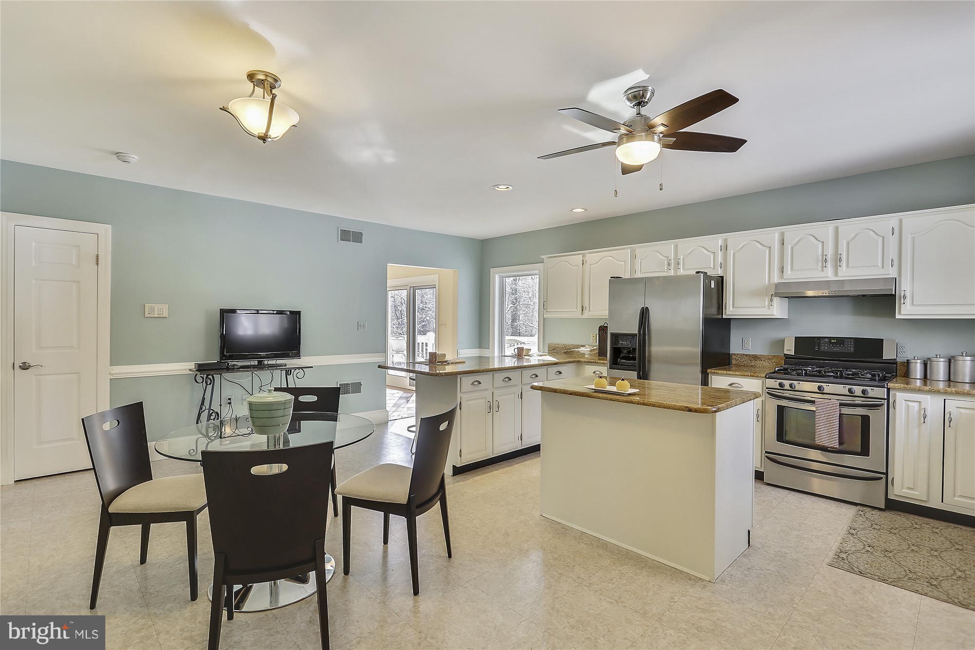 1711 Ashton Road Ashton, MD 20861 - Photo 6 of 30 a kitchen with a dining table and chairs