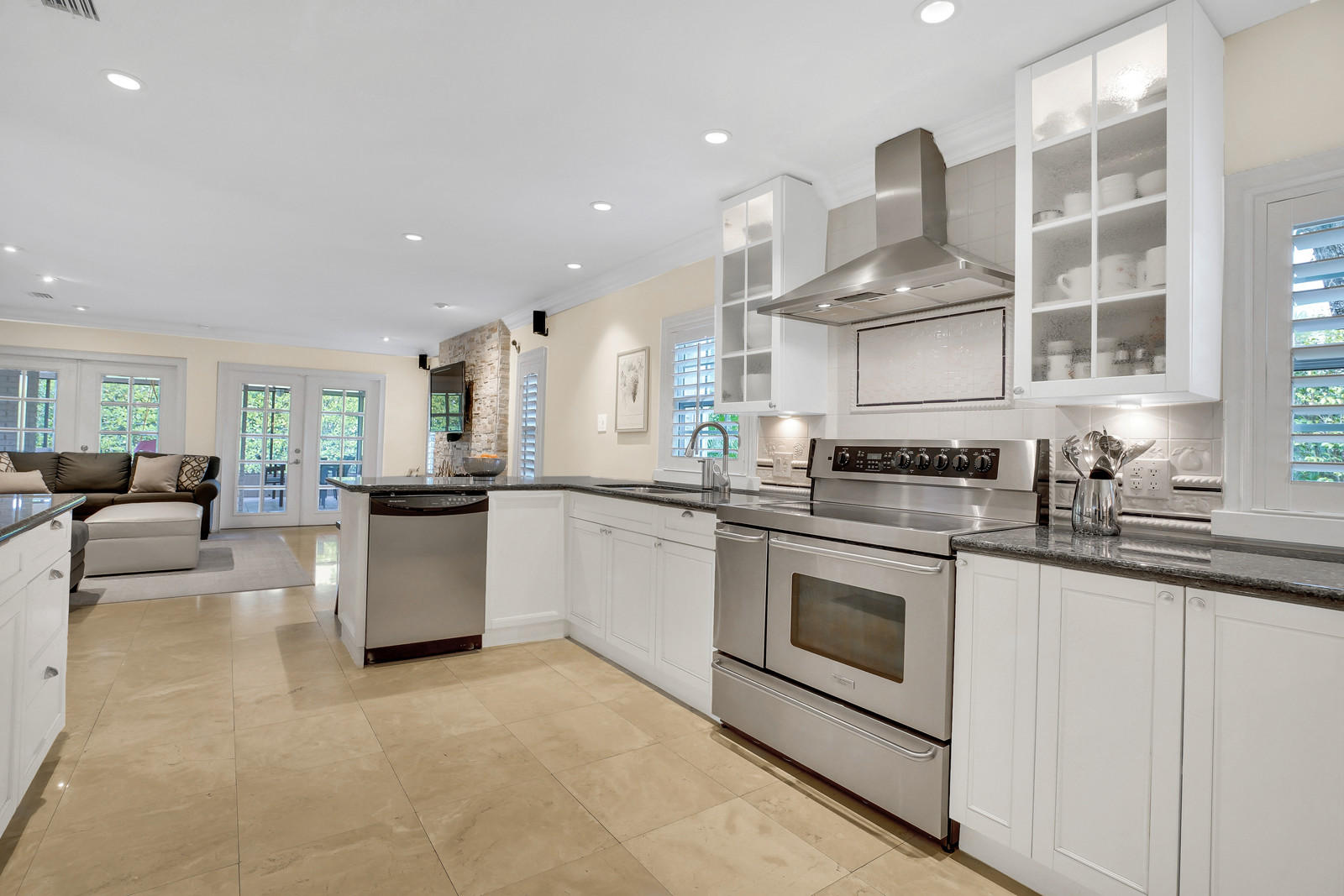 979 Southwest 18th Street Boca Raton, FL 33486 - Photo 15 of 30 a kitchen with stainless steel appliances granite countertop a stove and white cabinets