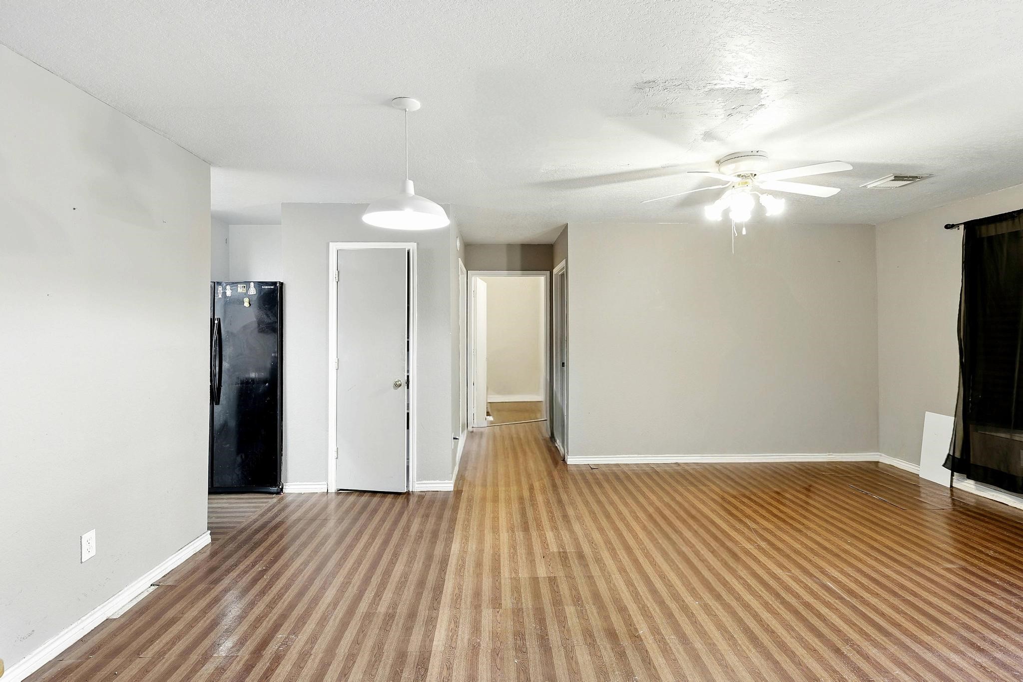 2005 Worms Street Houston, TX 77020 - Photo 3 of 11 a view of a room with wooden floor and a ceiling fan
