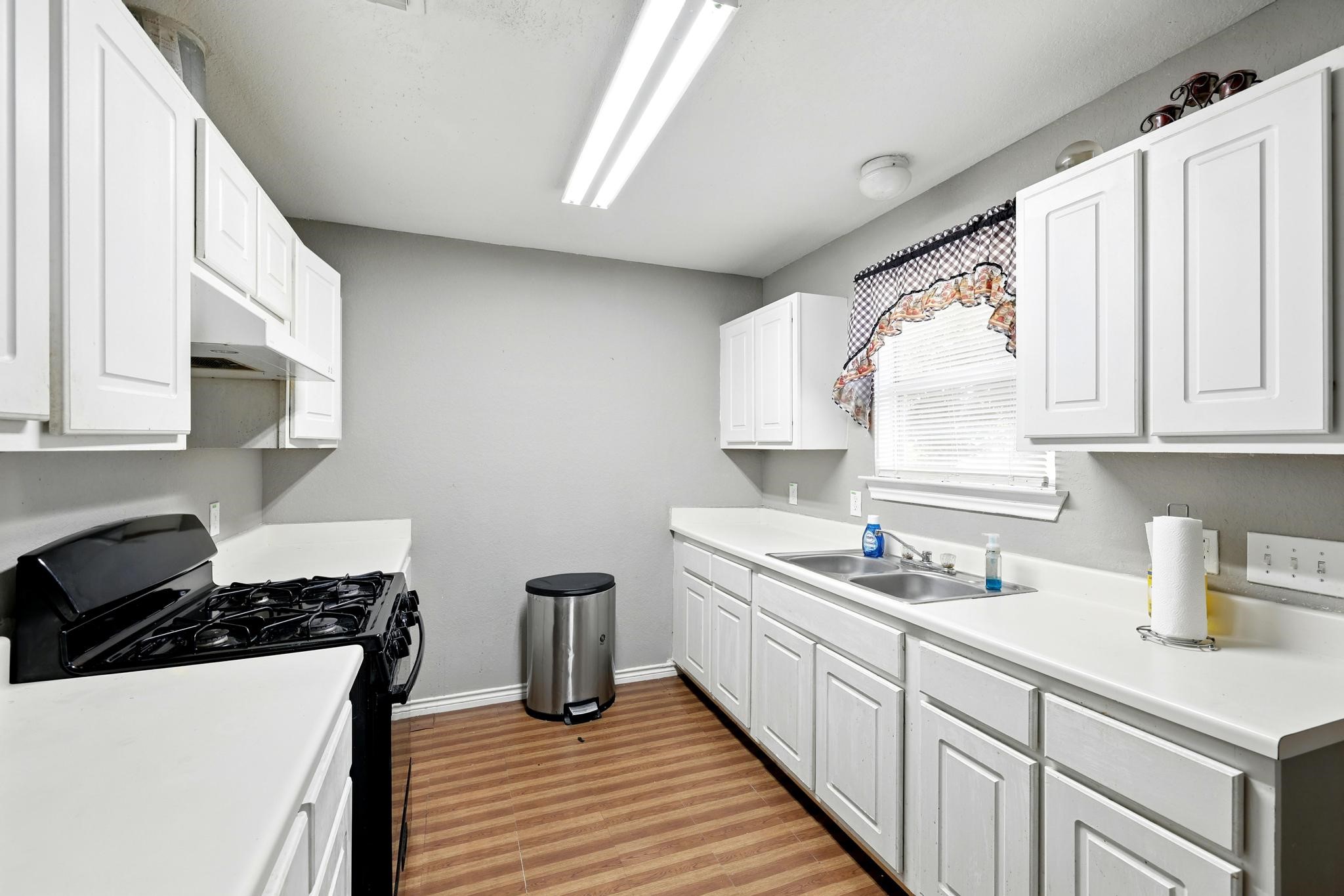 2005 Worms Street Houston, TX 77020 - Photo 4 of 11 a kitchen with a sink stove and cabinets