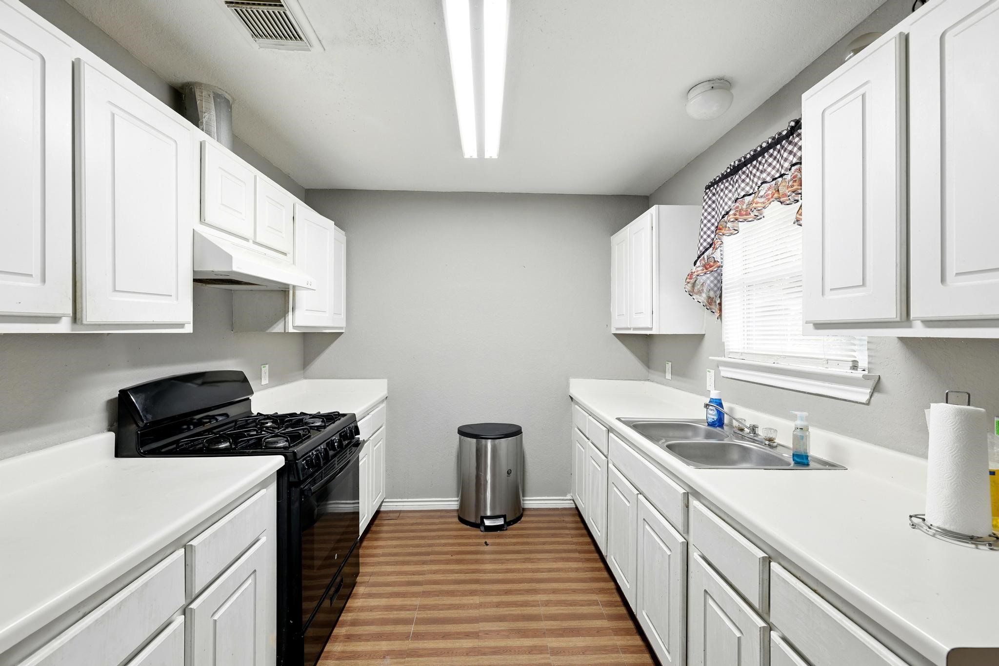2005 Worms Street Houston, TX 77020 - Photo 5 of 11 a kitchen with a sink a stove and cabinets