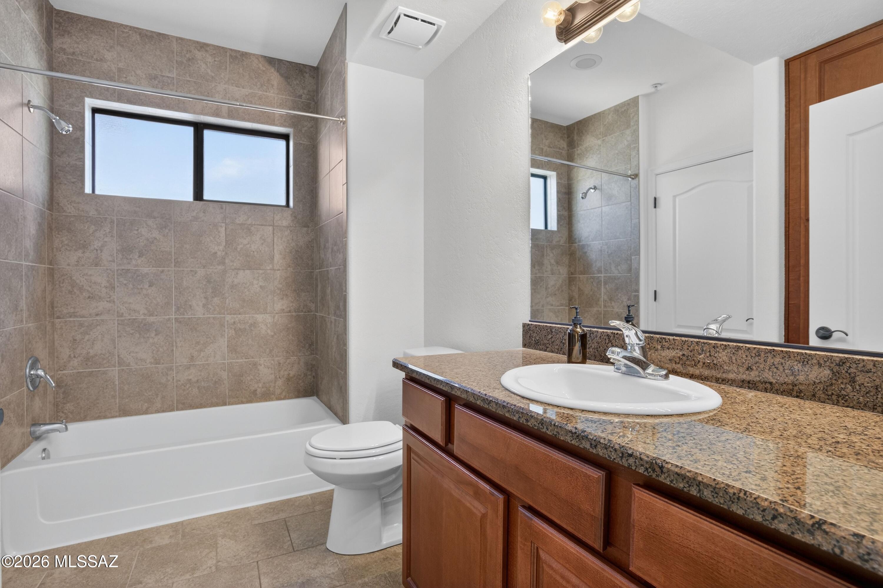 2550 East River Road, Unit 4204 Tucson, AZ 85718 - Photo 25 of 36 a bathroom with a granite countertop sink toilet and shower