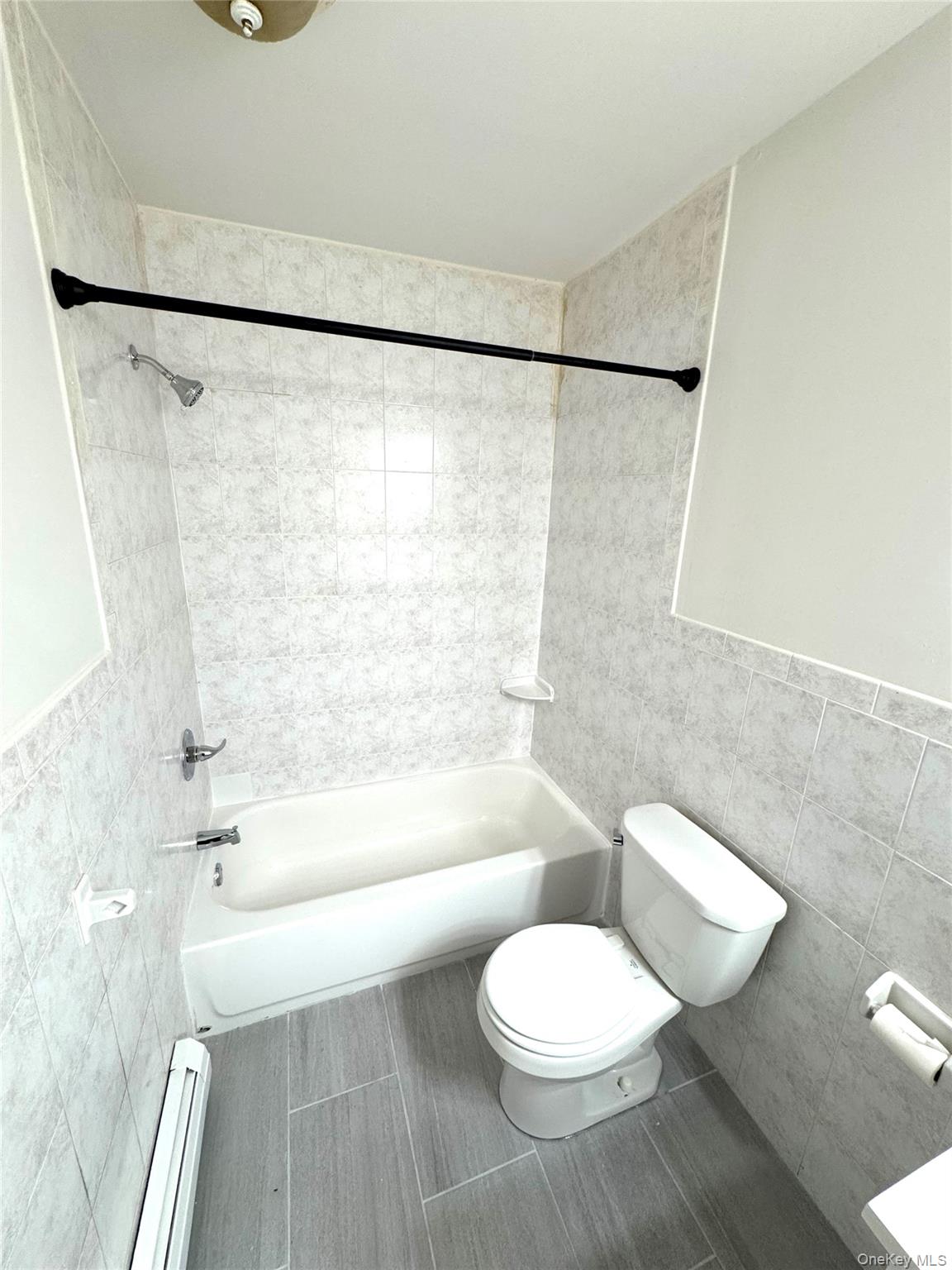 315 Main Street, Unit 3 Poughkeepsie, NY 12601 - Photo 7 of 13 a bathroom with a toilet a sink and bathtub