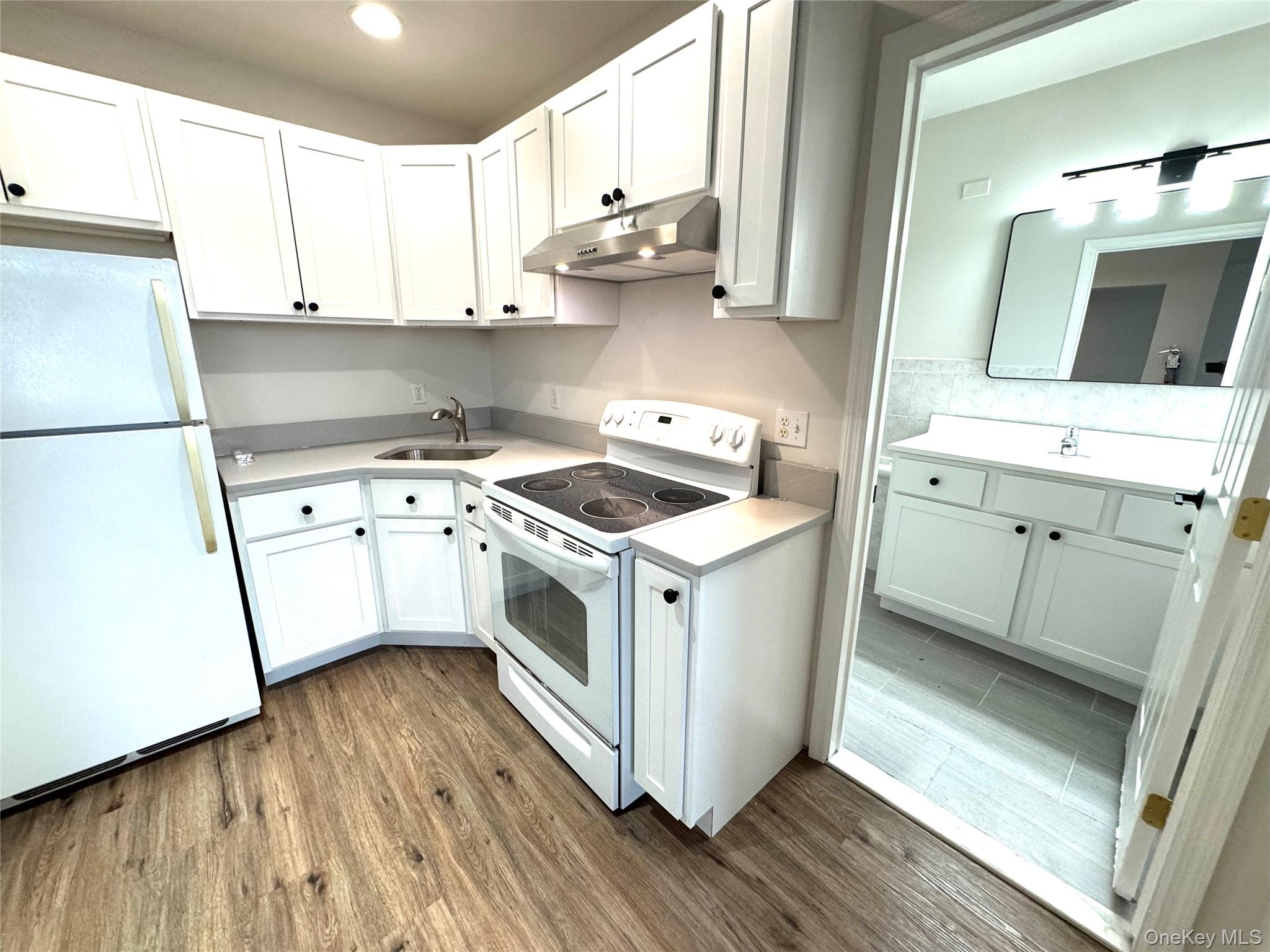 315 Main Street, Unit 3 Poughkeepsie, NY 12601 - Photo 9 of 13 a utility room with wooden floor washer and dryer