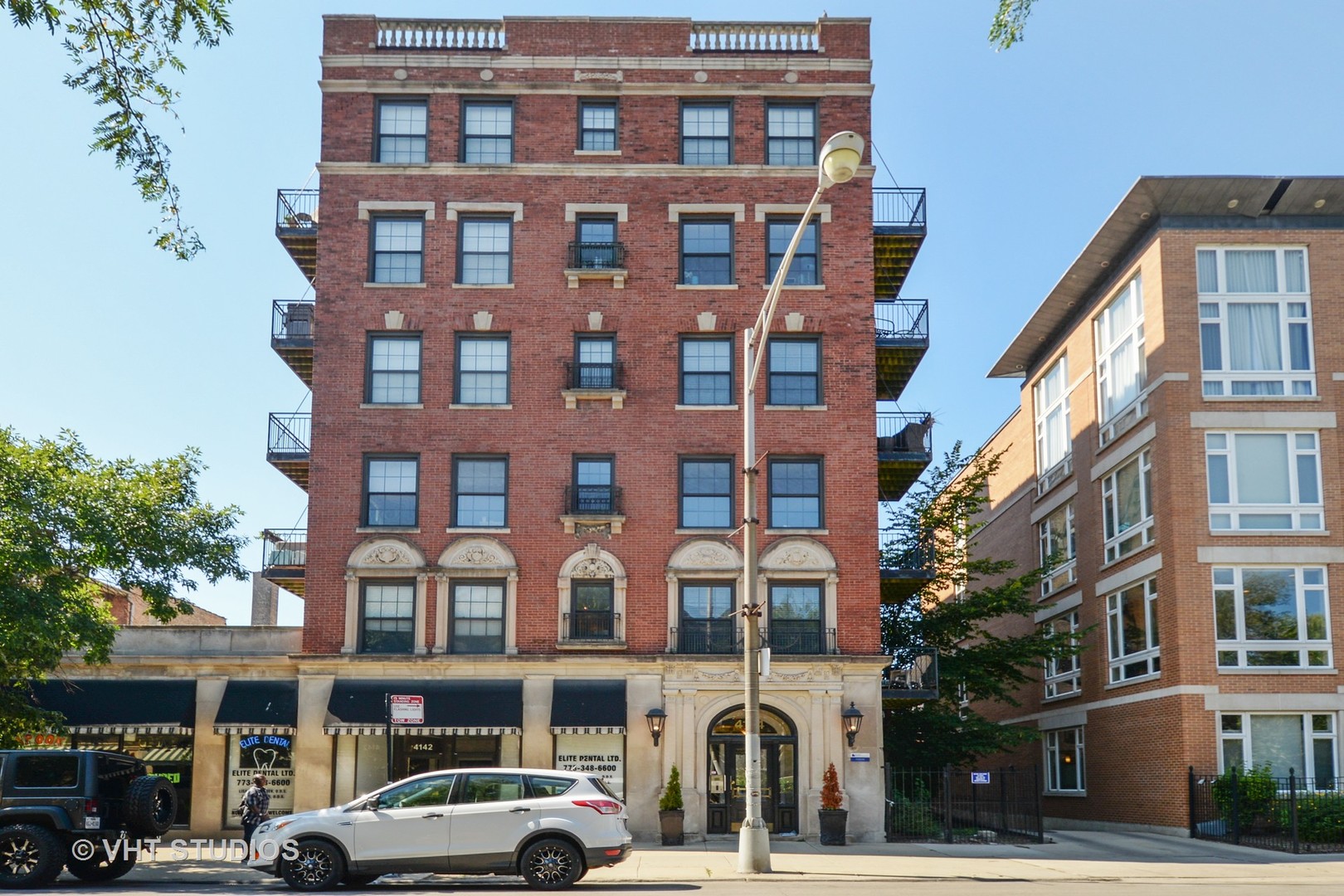 4144 North Sheridan Road, Unit 311 Chicago, IL 60613 - Photo 1 of 10 a front view of a building with lot of cars and trees